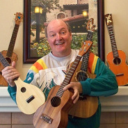 Photograph of instructor Doug Reynolds with several ukuleles.